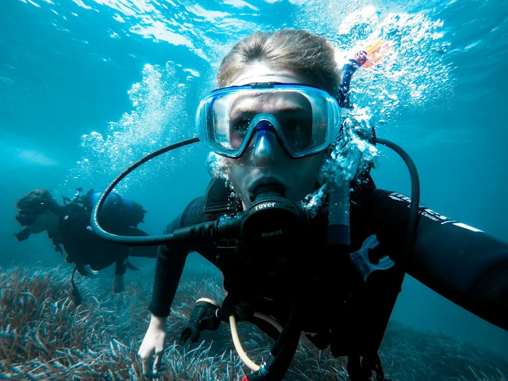 suba diving buddies swining on the reef